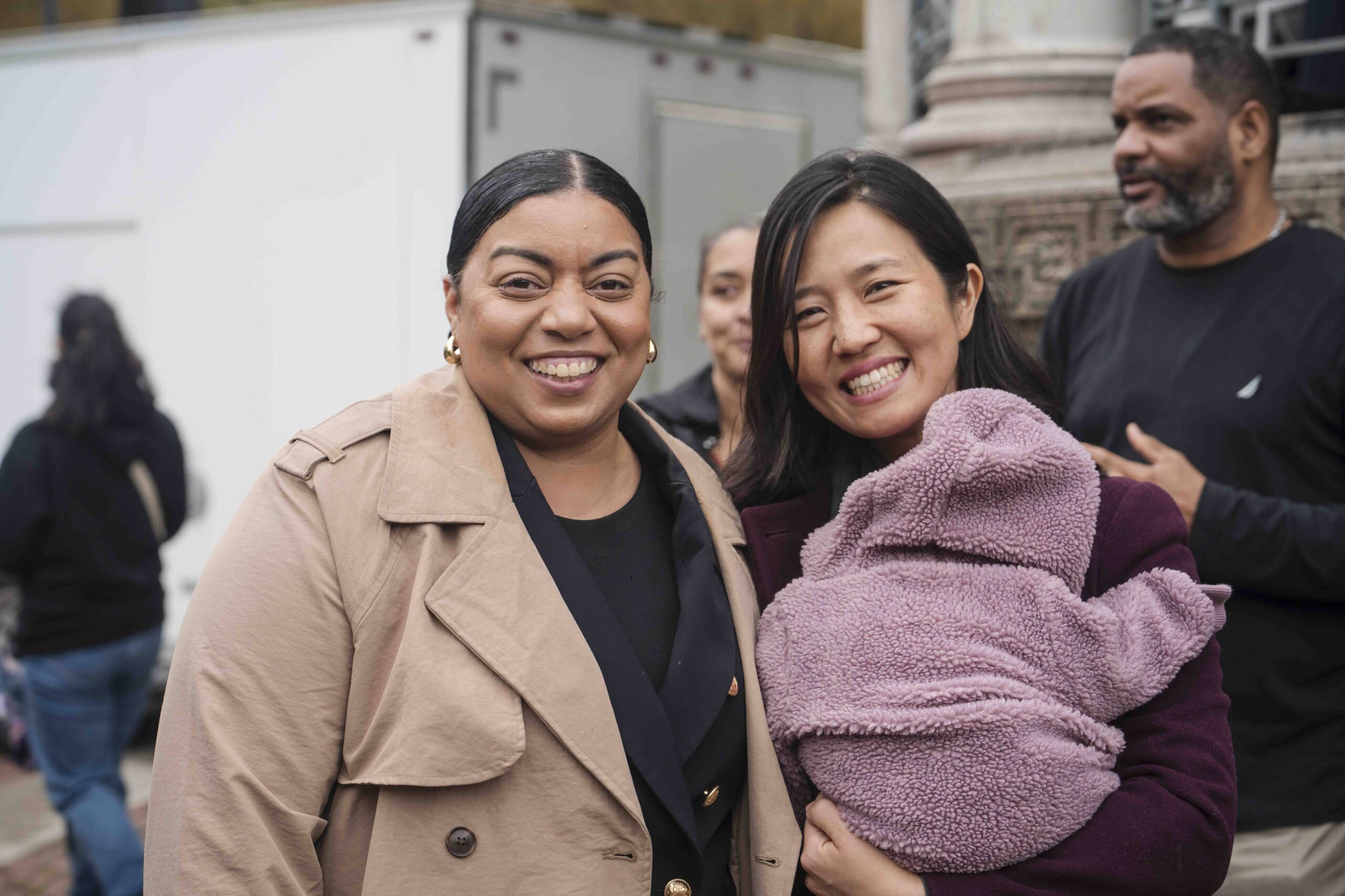 Two people smiling for the camera, outside at the Embrace Freedom Rally