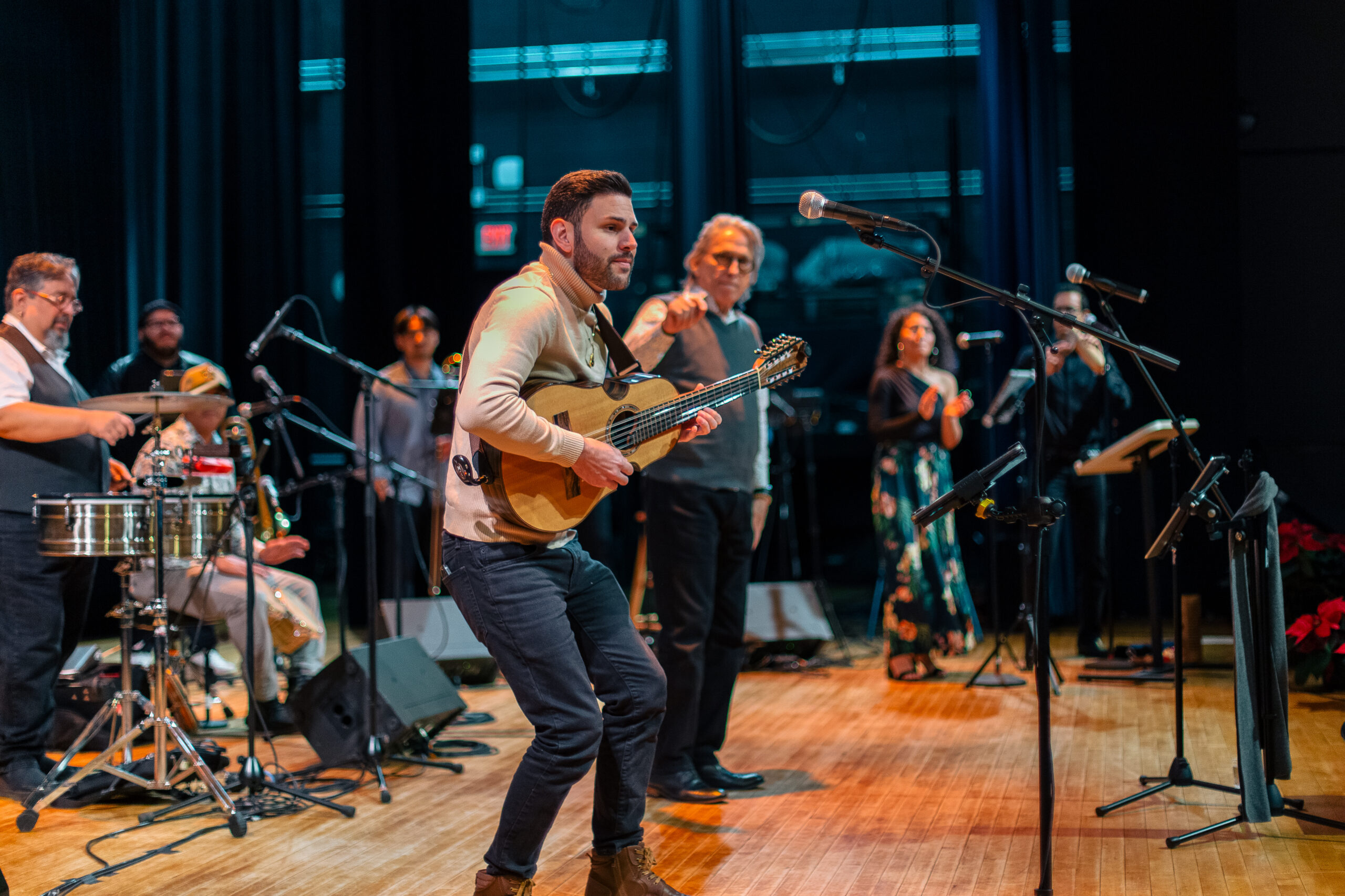 A group of musicians on stage, playing instruments