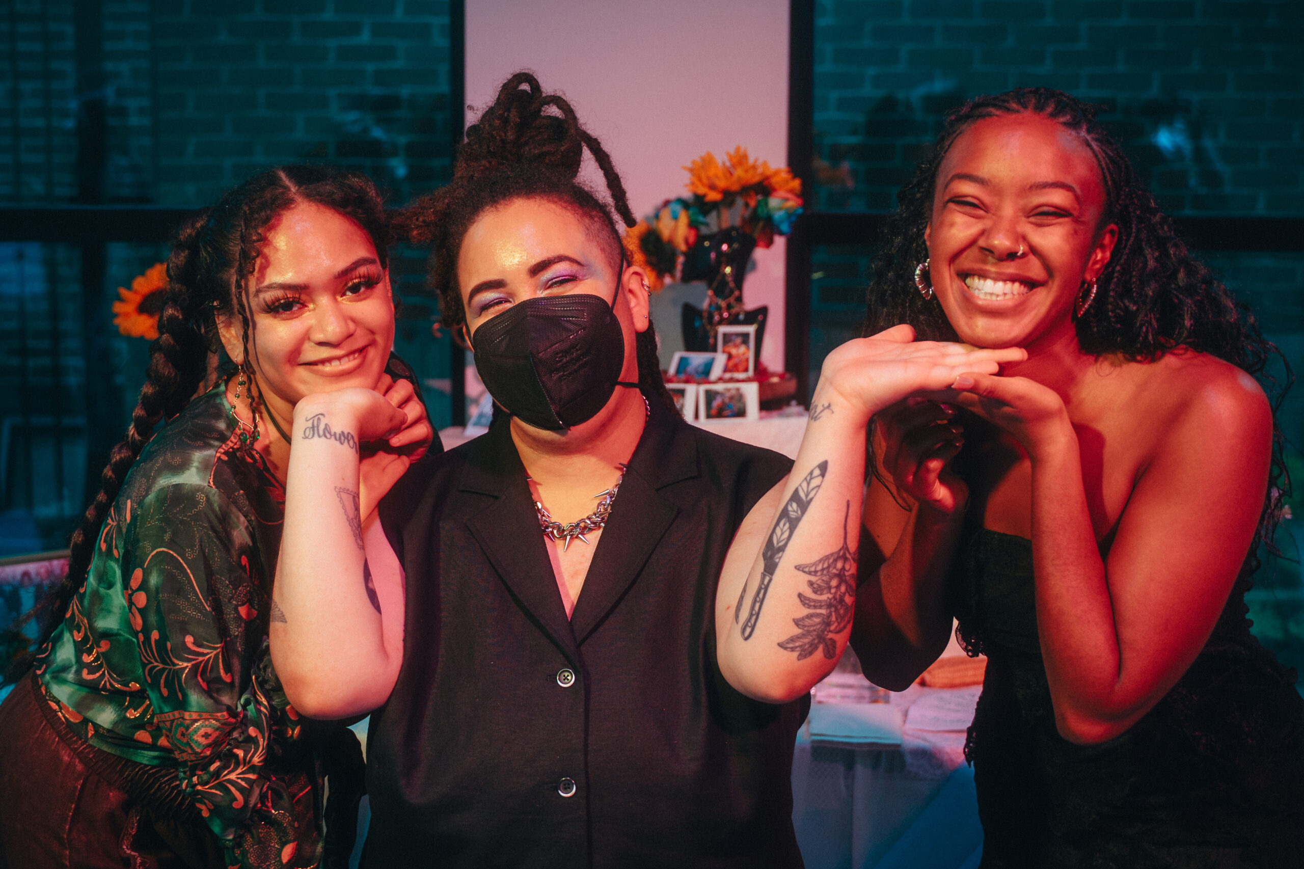 Three people smiling at the camera on Micah Fong Opening Night
